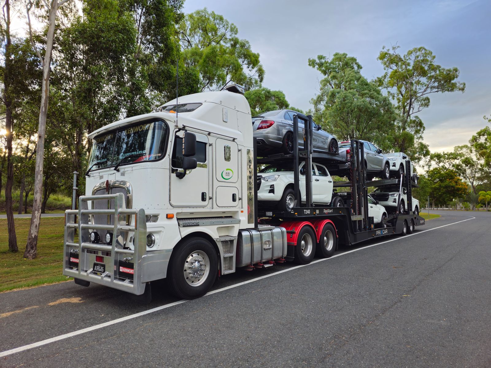 A multi-car auto-transport carrier loaded with vehicles on the highway